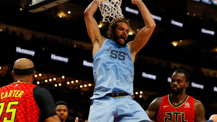 ATLANTA, GEORGIA - MARCH 13: Joakim Noah #55 of the Memphis Grizzlies dunks against Vince Carter #15 and Dewayne Dedmon #14 of the Atlanta Hawks in the first half at State Farm Arena on March 13, 2019 in Atlanta, Georgia. NOTE TO USER: User expressly acknowledges and agrees that, by downloading and or using this photograph, User is consenting to the terms and conditions of the Getty Images License Agreement. (Photo by Kevin C. Cox/Getty Images)