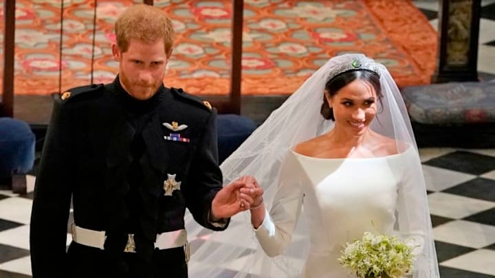 Britain's Prince Harry, Duke of Sussex (L) and Britain's Meghan Markle, Duchess of Sussex, (R) walk away from the High Altar toward the West Door to exit at the end of their wedding ceremony in St George's Chapel, Windsor Castle, in Windsor, on May 19, 2018. (Photo by Owen Humphreys / POOL / AFP) (Photo credit should read OWEN HUMPHREYS/AFP/Getty Images)