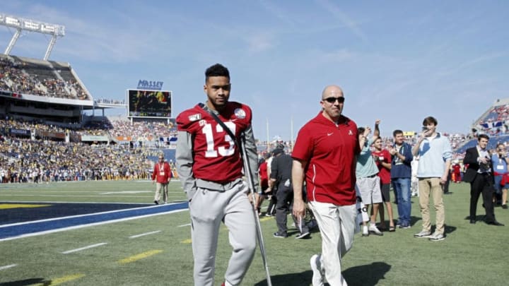 ORLANDO, FL - JANUARY 01: Injured quarterback Tua Tagovailoa #13 of the Alabama Crimson Tide leaves the field following warmups prior to the Vrbo Citrus Bowl against the Michigan Wolverines at Camping World Stadium on January 1, 2020 in Orlando, Florida. Alabama defeated Michigan 35-16. (Photo by Joe Robbins/Getty Images)