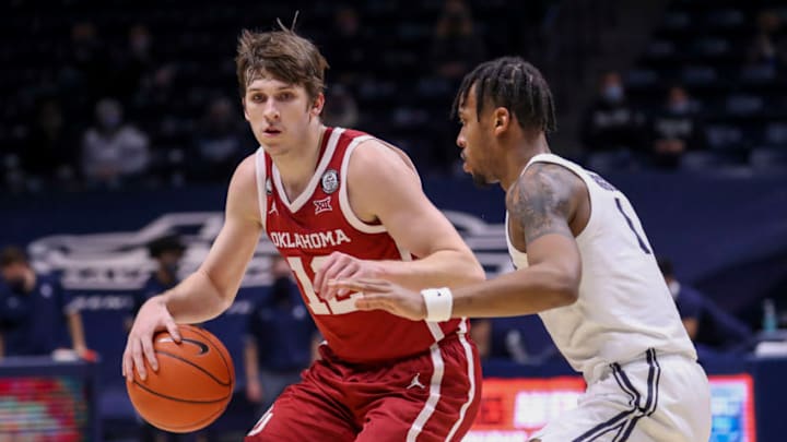 Dec 9, 2020; Cincinnati, Ohio, USA; Oklahoma Sooners guard Austin Reaves (12) dribbles against Xavier Musketeers guard Paul Scruggs (1) in the second half at Cintas Center. Mandatory Credit: Katie Stratman-USA TODAY Sports