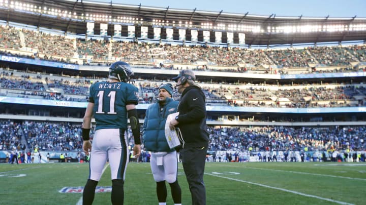 PHILADELPHIA, PA - JANUARY 01: Head coach Doug Pederson of the Philadelphia Eagles talks with quarterback Carson Wentz #11 and Chase Daniel #10 during a game against the Dallas Cowboys at Lincoln Financial Field on January 1, 2017 in Philadelphia, Pennsylvania. The Eagles defeated the Cowboys 27-13. (Photo by Rich Schultz/Getty Images)