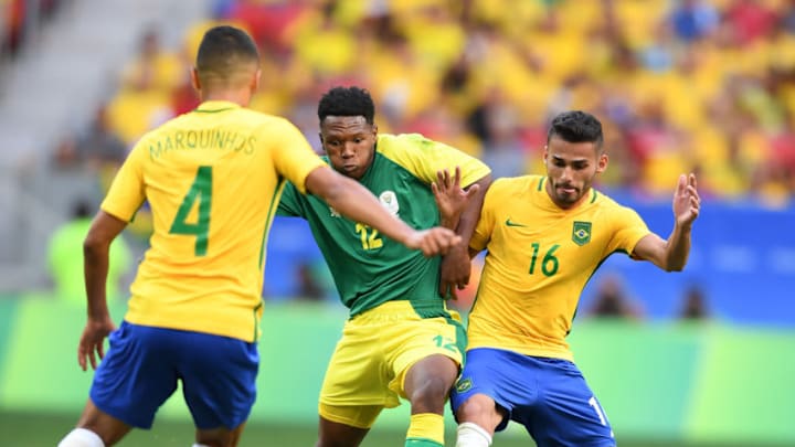 BRASILIA, Aug. 4, 2016 : Thiago Maia of Brazil, right, vies with Mothiba Lebo, center, during the men's group A football match between Brazil and South Africa at the 2016 Olympic Games, in Brasilia, Brazil, on Aug. 4, 2016. The match ended with 0-0 draw. (Xinhua/Yin Bogu via Getty Images)