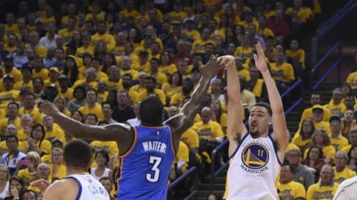 May 16, 2016; Oakland, CA, USA; Golden State Warriors guard Klay Thompson (11) shoots the basketball against Oklahoma City Thunder guard Dion Waiters (3) during the second quarter in game one of the Western conference finals of the NBA Playoffs at Oracle Arena. Mandatory Credit: Kyle Terada-USA TODAY Sports