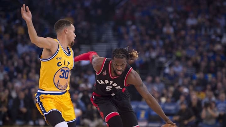 November 17, 2015; Oakland, CA, USA; Toronto Raptors forward DeMarre Carroll (5) dribbles the basketball against Golden State Warriors guard Stephen Curry (30) during the first quarter at Oracle Arena. Mandatory Credit: Kyle Terada-USA TODAY Sports