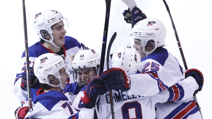 VANCOUVER , BC - JANUARY 5: Noah Cates #21 of the United States celebrates a goal with teammates Quinn Hughes #7, Jack Hughes #6, Alexander Chmelevski #8 and Phil Kemp #25 against Finland during a gold medal game at the IIHF World Junior Championships at Rogers Arena on January 5, 2019 in Vancouver, British Columbia, Canada. (Photo by Kevin Light/Getty Images)