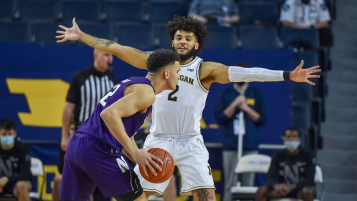 ANN ARBOR, MICHIGAN - JANUARY 03: Isaiah Livers #2 of the Michigan Wolverines defends against Pete Nance #22 of the Northwestern Wildcats during the second half of a college basketball game at Crisler Arena on January 3, 2021 in Ann Arbor, Michigan. The Michigan Wolverines won the game 85-66. (Photo by Aaron J. Thornton/Getty Images)