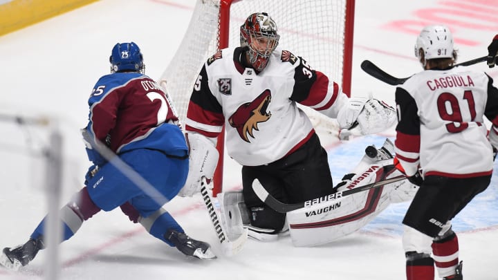 Mar 8, 2021; Denver, Colorado, USA; Arizona Coyotes goaltender Darcy Kuemper (35) makes a pad save on right wing Logan O’Connor (25) in the first period at Ball Arena. Mandatory Credit: Ron Chenoy-USA TODAY Sports