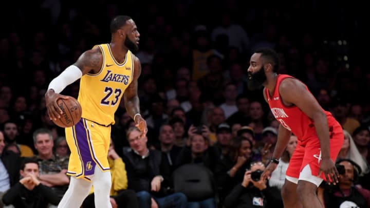 LOS ANGELES, CALIFORNIA - FEBRUARY 21: LeBron James #23 of the Los Angeles Lakers dribbles toward James Harden #13 of the Houston Rockets during the first half at Staples Center on February 21, 2019 in Los Angeles, California. (Photo by Harry How/Getty Images)