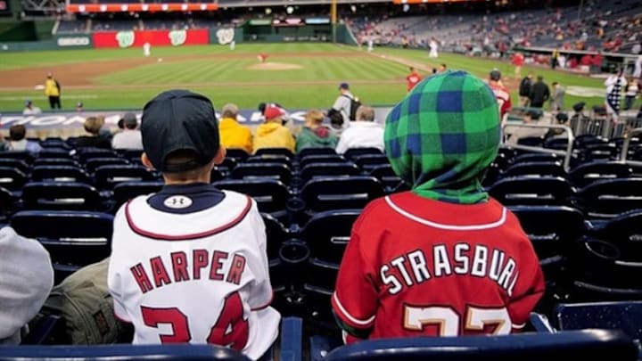 September 6, 2011; Washington DC, USA; Washington Nationals fans wear the jerseys of pitcher Stephen Strasburg and outfielder Bryce Harper prior to the game against the Los Angeles Dodgers at Nationals Park. Mandatory Credit: Evan Habeeb-USA TODAY Sports