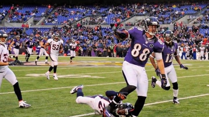 December 16, 2012;Baltimore, MD, USA;Baltimore Ravens tight end Dennis Pitta (88) breaks a tackle of Denver Broncos safety Rahim Moore (26) on the way to a 61 yard touchdown at M&T Bank Stadium in Baltimore. Mandatory Photo Credit: USA Today Sports
