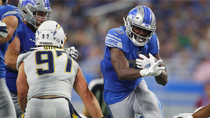 DETROIT, MICHIGAN – SEPTEMBER 15: Kerryon Johnson #33 of the Detroit Lions looks for yards during a second-quarter run behind Joey Bosa #97 of the Los Angeles Chargers at Ford Field on September 15, 2019, in Detroit, Michigan. (Photo by Gregory Shamus/Getty Images)