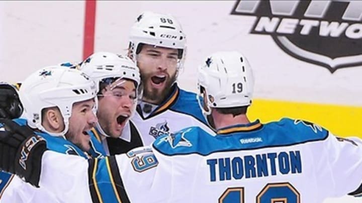 May 3, 2013; Vancouver, British Columbia, CAN; San Jose Sharks center Joe Thornton (19) is congratulated by teammates after scoring against Vancouver Canucks goaltender Roberto Luongo (1) (not pictured) during the first period of game two of the first round of the 2013 Stanley Cup playoffs at Rogers Arena. Mandatory Credit: Anne-Marie Sorvin-USA TODAY Sports