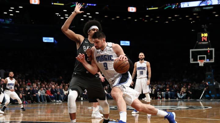 NEW YORK, NEW YORK – JANUARY 23: Nikola Vucevic #9 of the Orlando Magic drives against Jarrett Allen #31 of the Brooklyn Nets during their game at the Barclays Center on January 23, 2019 in New York City. NOTE TO USER: User expressly acknowledges and agrees that, by downloading and or using this photograph, User is consenting to the terms and conditions of the Getty Images License Agreement. (Photo by Al Bello/Getty Images)