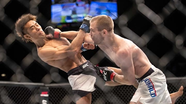 Jan 2, 2016; Las Vegas, NV, USA; Michael McDonald (red gloves) competes against Masanori Kanehara (blue gloves) during UFC 195 at MGM Grand Garden Arena. Mandatory Credit: Joshua Dahl-USA TODAY Sports