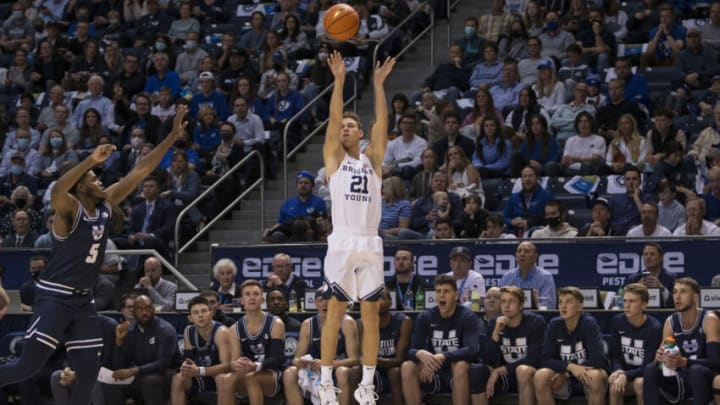SALT LAKE CITY, UT - DECEMBER 8: Trevin Knell #21 of the BYU Cougars shoots a three-pointer over RJ Eytle-Rock #5 of the Utah State Aggies during the first half December 8, 2021 at the J. Willard Marriott Center in Salt Lake City, Utah.(Photo by Chris Gardner/Getty Images)