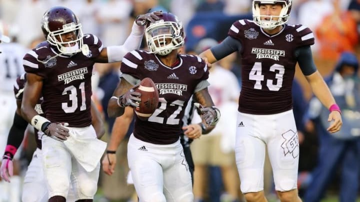 Oct 11, 2014; Starkville, MS, USA; Mississippi State Bulldogs linebacker Matthew Wells (22) celebrates after recovering a fumble during the game against the Auburn Tigers at Davis Wade Stadium. Mississippi State Bulldogs defeated the Auburn Tigers 38-23. Mandatory Credit: Spruce Derden-USA TODAY Sports