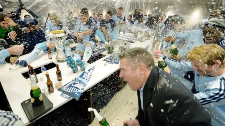 Sporting KC head coach Peter Vermes, right, joins the team in celebrating in the locker room after defeating Real Salt Lake in the MLS Cup Final at Sporting Park in Kansas City, Kan., Saturday, Dec. 7, 2013. Sporting won on penalty kicks. (John Sleezer/Kansas City Star/Tribune News Service via Getty Images)