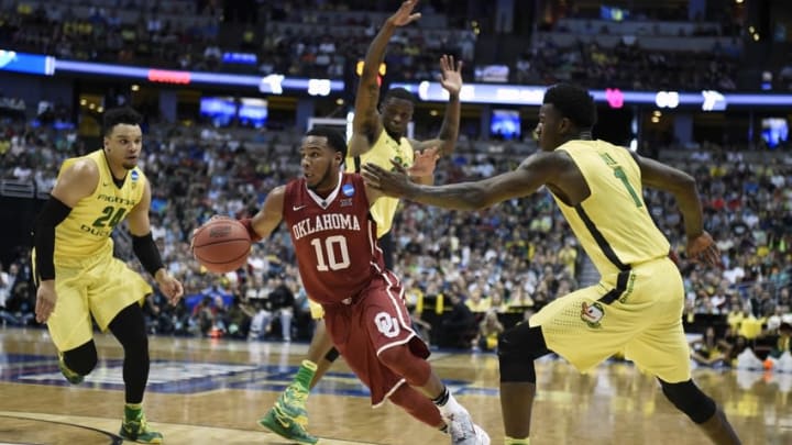 March 26, 2016; Anaheim, CA, USA; Oklahoma Sooners guard Jordan Woodard (10) moves the ball against Oregon Ducks forward Dillon Brooks (24) and forward Jordan Bell (1) during the second half of the West regional final of the NCAA Tournament at Honda Center. Mandatory Credit: Richard Mackson-USA TODAY Sports