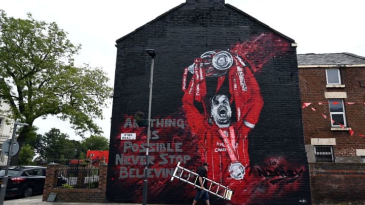 TOPSHOT - The finished new mural of Liverpool's English midfielder Jordan Henderson lifting the Premier League trophy created by graffiti artists MurWalls ein collaboration with The Redmen TV, independent Liverpool FC media, is seen on the side of a house outside Anfield stadium in Liverpool, northwest England, on July 25, 2020 - The mural being produced by The Redmen in partnership with licensed graffiti artists MurWalls outside Anfield is a celebration of Liverpool's Premier League title triumph and the career of club captin Jordan Henderson. (Photo by Paul ELLIS / AFP) / RESTRICTED TO EDITORIAL USE - MANDATORY MENTION OF THE ARTIST UPON PUBLICATION - TO ILLUSTRATE THE EVENT AS SPECIFIED IN THE CAPTION (Photo by PAUL ELLIS/AFP via Getty Images)