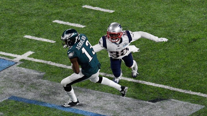 MINNEAPOLIS, MN – FEBRUARY 04: Nelson Agholor #13 of the Philadelphia Eagles breaks a tackle from Devin McCourty #32 of the New England Patriots during the second half in Super Bowl LII at U.S. Bank Stadium on February 4, 2018 in Minneapolis, Minnesota. (Photo by Hannah Foslien/Getty Images)