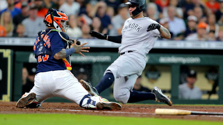 Jul 11, 2021; Houston, Texas, USA; New York Yankees catcher Gary Sanchez (24) slides into home plate to score a run against the Houston Astros during the third inning at Minute Maid Park. Mandatory Credit: Erik Williams-USA TODAY Sports