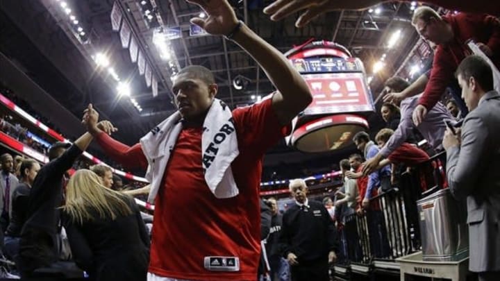 Jan 15, 2014; Washington, DC, USA; Washington Wizards shooting guard Bradley Beal (3) celebrates with fans while leaving the court after the Wizards