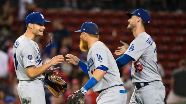 BOSTON, MA - JULY 15: Joe Kelly #17 celebrates with teammates Justin Turner #10 and Cody Bellinger #35 of the Los Angeles Dodgers after beating the Boston Red Sox in twelve innings at Fenway Park on July 15, 2019 in Boston, Massachusetts. (Photo by Kathryn Riley/Getty Images)