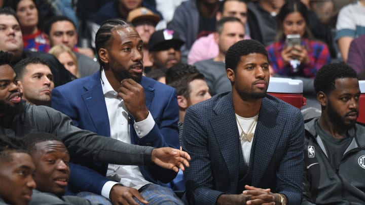 LOS ANGELES, CA – NOVEMBER 6: Kawhi Leonard #2, and Paul George #13 of the LA Clippers look on during the game against the Milwaukee Bucks on November 6, 2019 at STAPLES Center in Los Angeles, California. NOTE TO USER: User expressly acknowledges and agrees that, by downloading and/or using this Photograph, user is consenting to the terms and conditions of the Getty Images License Agreement. Mandatory Copyright Notice: Copyright 2019 NBAE (Photo by Andrew D. Bernstein/NBAE via Getty Images)