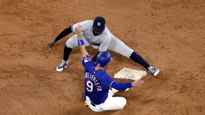 ARLINGTON, TX - MAY 23: Isiah Kiner-Falefa #9 of the Texas Rangers steals second base as Didi Gregorius #18 of the New York Yankees is late on the tag in the eighth inning of a baseball game at Globe Life Park in Arlington on May 23, 2018 in Arlington, Texas. (Photo by Richard Rodriguez/Getty Images)