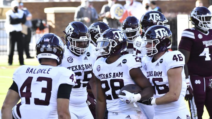 Oct 17, 2020; Starkville, Mississippi, USA; Texas A&M Aggies running back Isaiah Spiller (28) reacts with teammates after a touchdown against the Mississippi State Bulldogs during the second quarter at Davis Wade Stadium at Scott Field. Mandatory Credit: Matt Bush-USA TODAY Sports