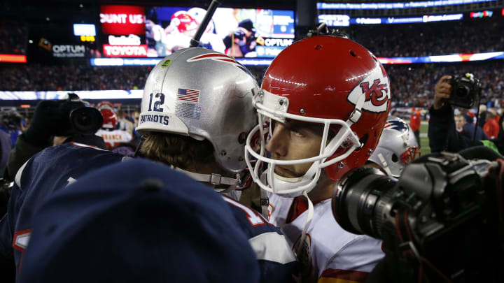 New England Patriots quarterback Tom Brady (12) hugs Kansas City Chiefs quarterback Alex Smith (11) – Mandatory Credit: David Butler II-USA TODAY Sports