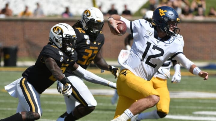 COLUMBIA, MISSOURI - SEPTEMBER 07: Quarterback Austin Kendall #12 of the West Virginia Mountaineers rushes past defensive back DeMarkus Acy #2 of the Missouri Tigers in the first half at Faurot Field/Memorial Stadium on September 07, 2019 in Columbia, Missouri. (Photo by Ed Zurga/Getty Images)