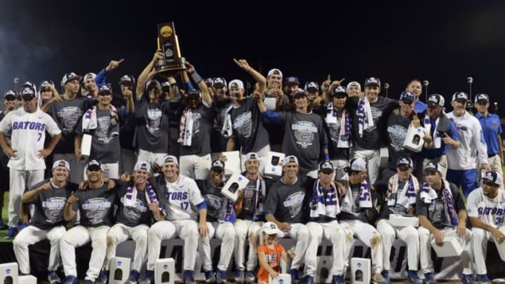 Jun 27, 2017; Omaha, NE, USA; Florida Gators players and coaches celebrate with the national championship trophy after the game against the LSU Tigers in game two of the championship series of the 2017 College World Series at TD Ameritrade Park Omaha. Mandatory Credit: Steven Branscombe-USA TODAY Sports