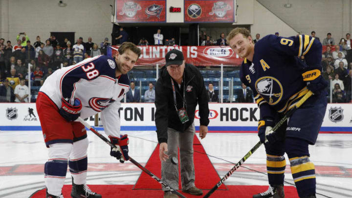 CLINTON, NY - SEPTEMBER 25: Mike Orsino participates in a ceremonial puck drop with Boone Jenner #38 of the Columbus Blue Jackets and Jack Eichel #9 of the Buffalo Sabres before a preseason game during the NHL Kraft Hockeyville USA at Clinton Arena on September 25, 2018 in Clinton, New York. (Photo by Patrick McDermott/NHLI via Getty Images)