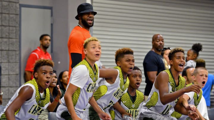 NBA star LeBron James, center/back facing camera, reacts along with his son, LeBron Jr., left and his teammates on a play during a youth tournament at the Charlotte Convention Center in Charlotte, N.C., on Friday, July 21, 2017. (Jeff Siner/Charlotte Observer/TNS via Getty Images)