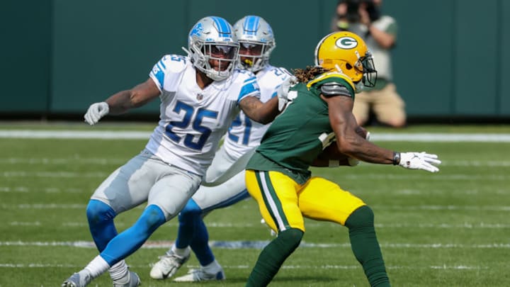 GREEN BAY, WISCONSIN - SEPTEMBER 20: Davante Adams #17 of the Green Bay Packers runs with the ball while being tackled by Will Harris #25 of the Detroit Lions in the second quarter at Lambeau Field on September 20, 2020 in Green Bay, Wisconsin. (Photo by Dylan Buell/Getty Images)