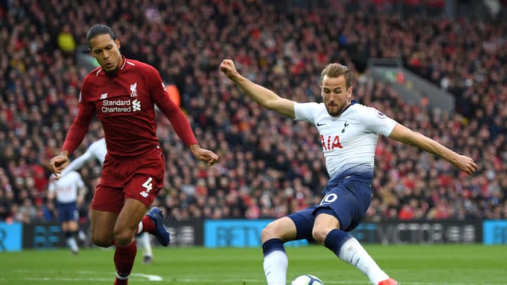 LIVERPOOL, ENGLAND - MARCH 31: Harry Kane of Tottenham Hotspur shoots under pressure from Virgil Van Dijk of Liverpool during the Premier League match between Liverpool FC and Tottenham Hotspur at Anfield on March 31, 2019 in Liverpool, United Kingdom. (Photo by Shaun Botterill/Getty Images)