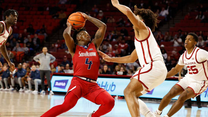 Nov 18, 2022; Norman, Oklahoma, USA; South Alabama Jaguars guard Isaiah Moore (4) is defended by Oklahoma Sooners forward Jalen Hill (1) during the first half at Lloyd Noble Center. Mandatory Credit: Alonzo Adams-USA TODAY Sports