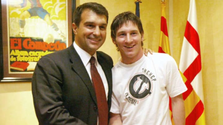 Barcelona, SPAIN: Barcelona’s Argentinian football player Lioneleo Messi (R) shakes hand with FC Barcelona’s President Joan Laporta (L) 16 September 2005 after Messi extended his contract until 2014 at Nou Camp Stadium in Barcelona. Messi has reached an agreement for the extension of the Argentinean player’s contract until 30 June 2014, and includes a 150 million euro buyout clause. AFP PHOTO/LLUIS GENE (Photo credit should read LLUIS GENE/AFP/Getty Images)
