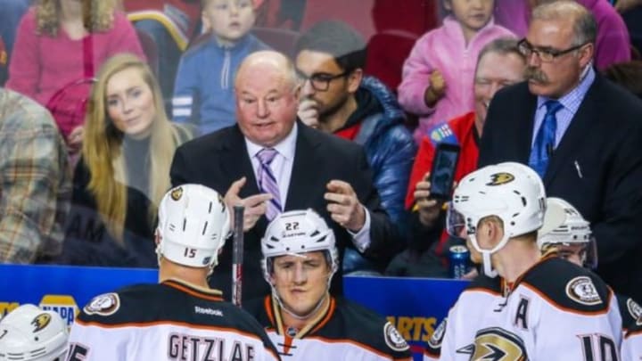 Dec 29, 2015; Calgary, Alberta, CAN; Anaheim Ducks head coach Bruce Boudreau (L) talks to his players from behind the bench against the Calgary Flames during the third period at Scotiabank Saddledome. The Ducks won 1-0. Mandatory Credit: Sergei Belski-USA TODAY Sports
