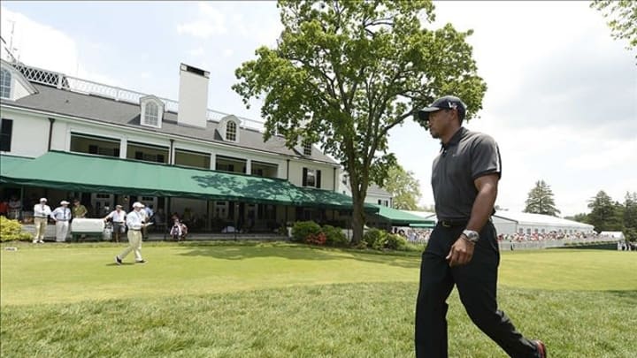 Jun 11, 2013; Ardmore, PA, USA; Tiger Woods walks to the first tee during the practice round of the 113th U.S. Open golf tournament at Merion Golf Club. Mandatory Credit: John David Mercer-USA TODAY Sports