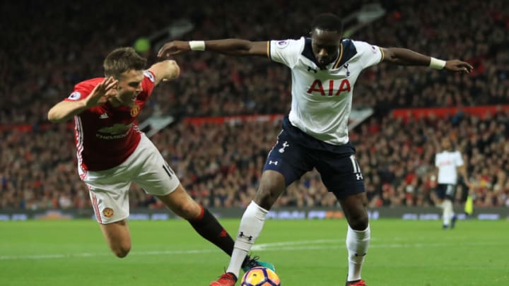 MANCHESTER, ENGLAND - DECEMBER 11: Moussa Sissoko of Tottenham Hotspur and Michael Carrick of Manchester United compete for the ball during the Premier League match between Manchester United and Tottenham Hotspur at Old Trafford on December 11, 2016 in Manchester, England. (Photo by Richard Heathcote/Getty Images)