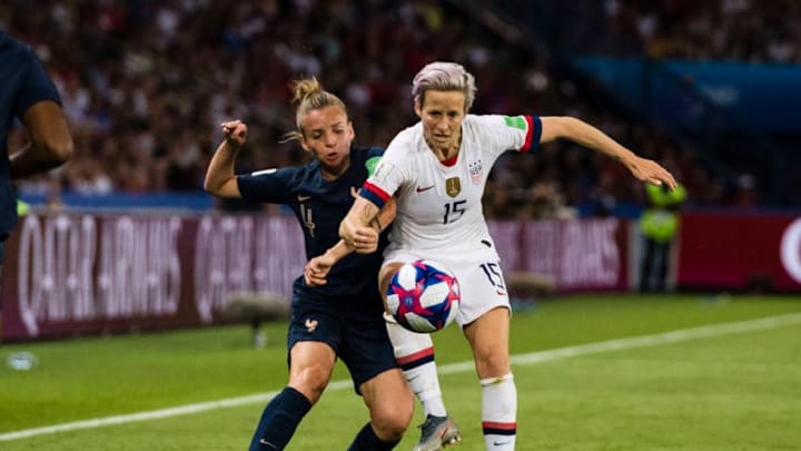 PARIS, FRANCE - JUNE 28: Megan Rapinoe of United States (R) ibattles for the ball with Marion Torrent of France (L) during the 2019 FIFA Women's World Cup France Quarter Final match between France and USA at Parc des Princes on June 28, 2019 in Paris, France. (Photo by Marcio Machado/Getty Images)