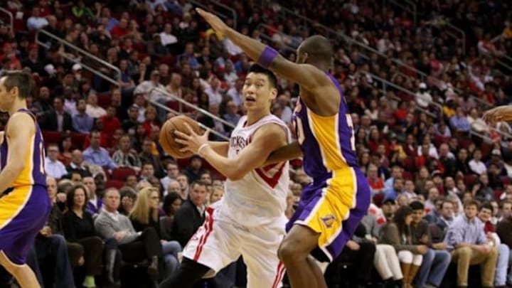 Jan 8, 2013; Houston, TX, USA; Houston Rockets point guard Jeremy Lin (left) drives to the basket during the third quarter against the Los Angeles Lakers at Toyota Center. Mandatory Credit: Troy Taormina-USA TODAY Sports