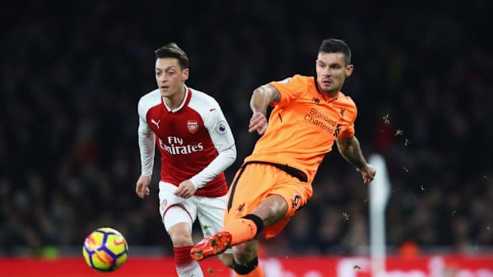 LONDON, ENGLAND - DECEMBER 22: Dejan Lovren of Liverpool clears the ball from Mesut Ozil of Arsenal during the Premier League match between Arsenal and Liverpool at Emirates Stadium on December 22, 2017 in London, England. (Photo by Julian Finney/Getty Images)