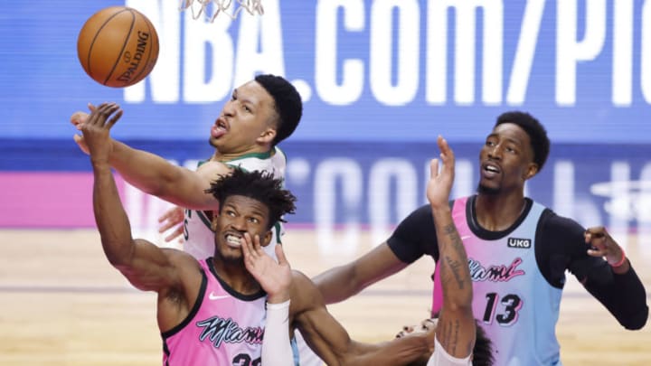 Jimmy Butler #22 of the Miami Heat battles for a rebound with Marcus Smart #36 and Grant Williams #12 of the Boston Celtics (Photo by Michael Reaves/Getty Images)