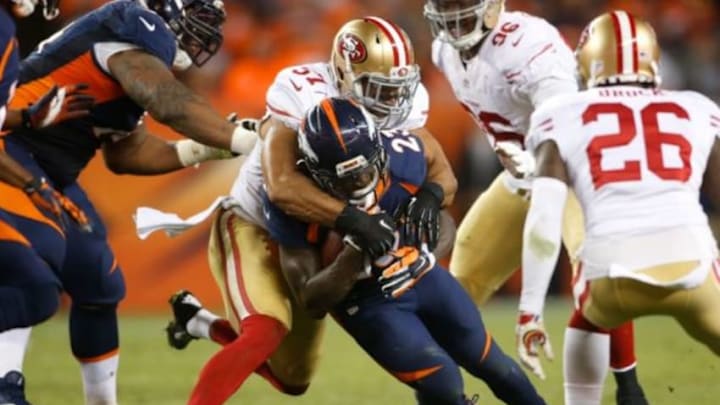 Oct 19, 2014; Denver, CO, USA; Denver Broncos running back Ronnie Hillman (23) is tackled by San Francisco 49ers inside linebacker Michael Wilhoite (57) in front of cornerback Tramaine Brock (26) in the fourth quarter at Sports Authority Field at Mile High. Mandatory Credit: Chris Humphreys-USA TODAY Sports