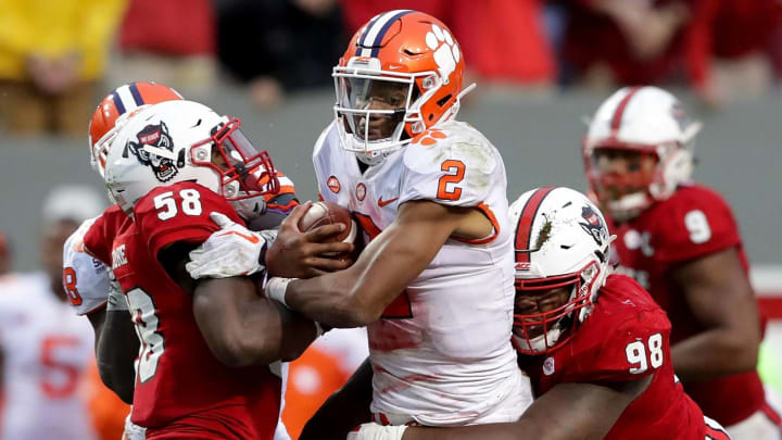 RALEIGH, NC – NOVEMBER 04: Teammates Airius Moore #58 and B.J. Hill #98 of the North Carolina State Wolfpack tackle Kelly Bryant #2 of the Clemson Tigers during their game at Carter Finley Stadium on November 4, 2017 in Raleigh, North Carolina. (Photo by Streeter Lecka/Getty Images)