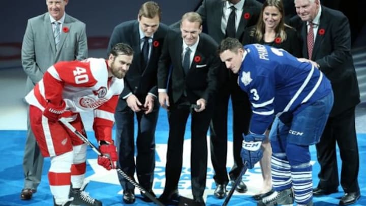 Nov 6, 2015; Toronto, Ontario, CAN; Detroit Red Wings left wing Henrik Zetterberg (40) and Toronto Maple Leafs defenseman Dion Phaneuf (3) pose for a ceremonial face-off as new Hall of Fame inductees Sergei Federov and Nicklas Lidstrom drop the puck before the start of the game at Air Canada Centre. Mandatory Credit: Tom Szczerbowski-USA TODAY Sports