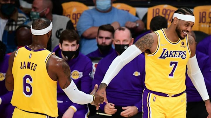 LeBron James and Carmelo Anthony of the Los Angeles Lakers touch hands in a break of action against the Golden State Warriors during their NBA season opener in Los Angeles, California on October 19, 2021. (Photo by Frederic J. BROWN / AFP) (Photo by FREDERIC J. BROWN/AFP via Getty Images) LeBron James and Carmelo Anthony of the Los Angeles Lakers touch hands in a break of action against the Golden State Warriors during their NBA season opener in Los Angeles, California on October 19, 2021. (Photo by Frederic J. BROWN / AFP) (Photo by FREDERIC J. BROWN/AFP via Getty Images)